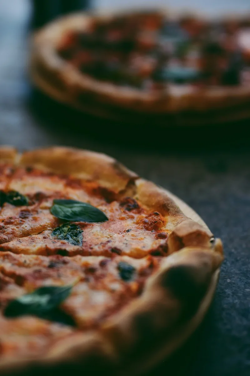 Pizza dough being hand stretched